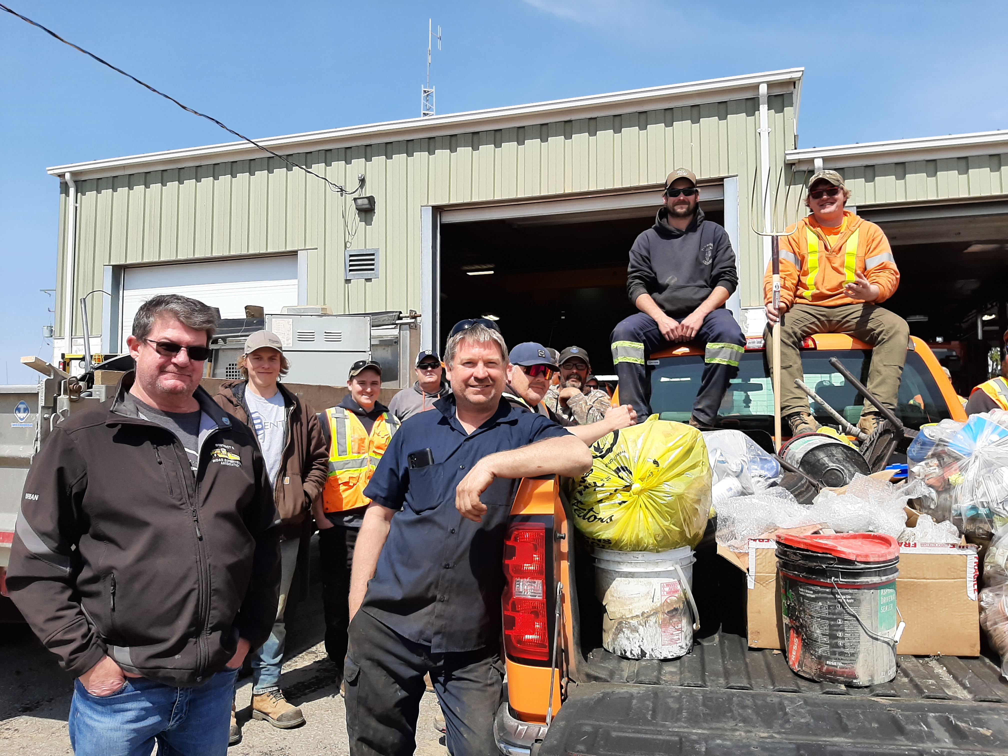 Public Services crews standing in front of a pick-up full of garbage