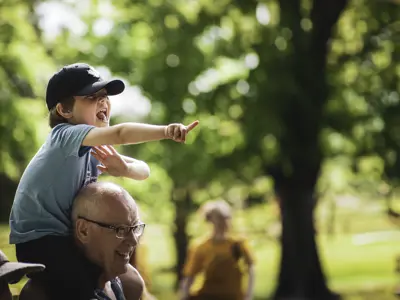Boy pointing on his Dad's shoulders