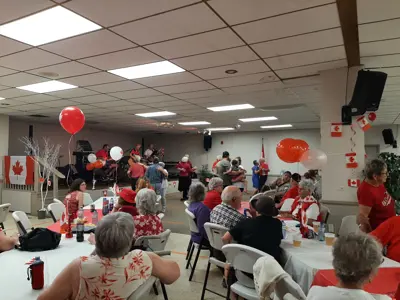 People dancing to music in a hall.