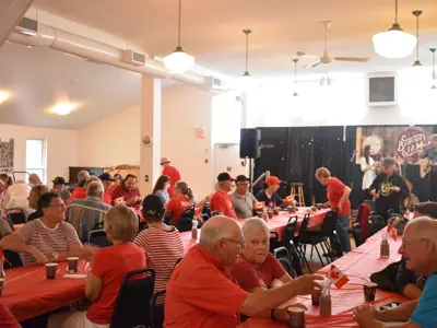 People sitting in a hall having breakfast
